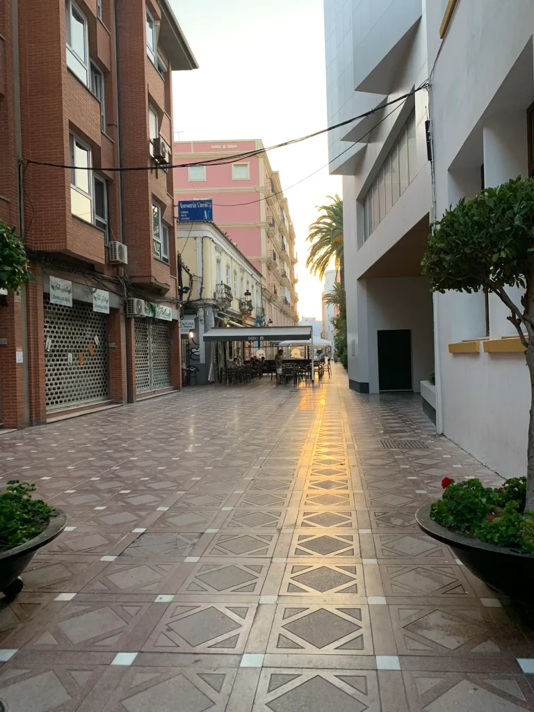 Pedestrian street in La Línea in the evening, tapas bars either side