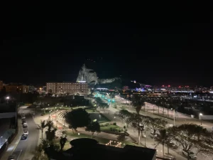 The Rock of Gibraltar at night seen past a fountain in La Linea.