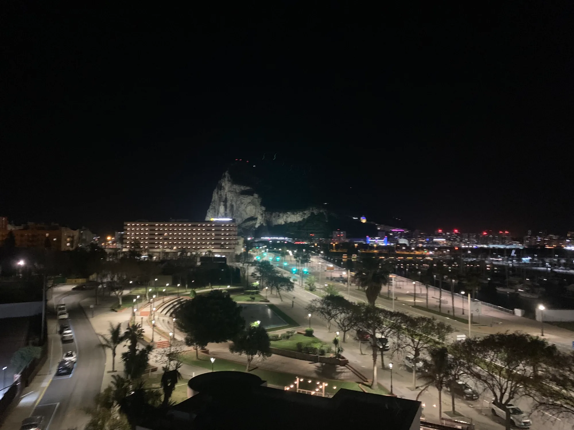 The Rock of Gibraltar at night seen past a fountain in La Linea.