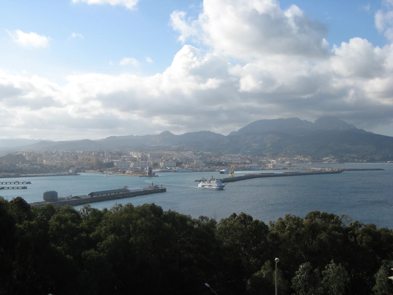 Daylight view across the port of Ceuta with the city and mountains behind